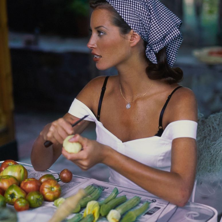 Image may contain: Christy Turlington, Adult, Person, Accessories, Jewelry, Necklace, Face, Head, Desk, Furniture, and Table